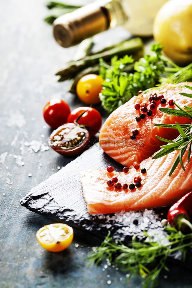 Similar – salmon, fresh herbs, oil and spoon on old wooden table