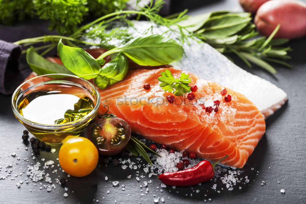 Similar – salmon, fresh herbs, oil and spoon on old wooden table