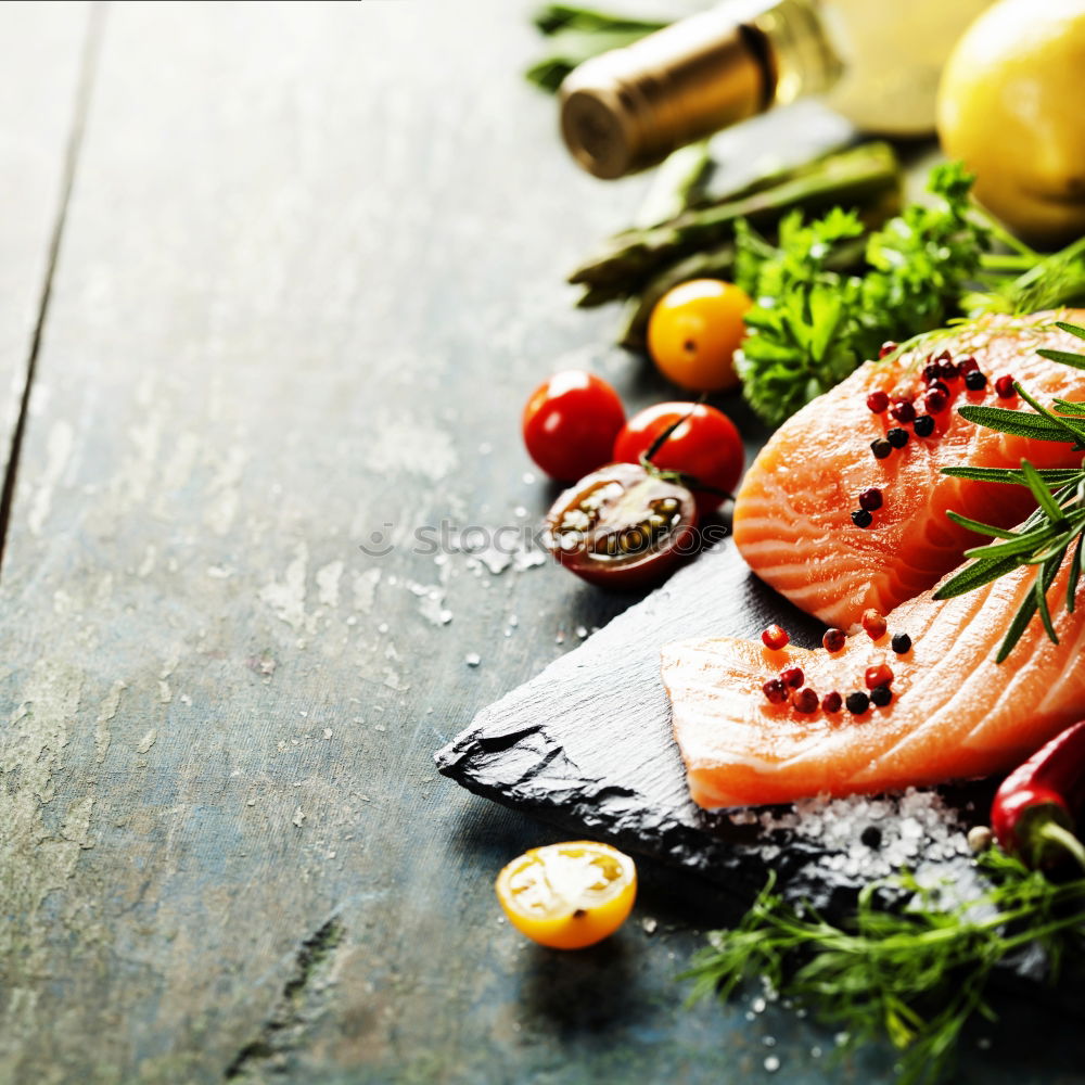 Similar – salmon, fresh herbs, oil and spoon on old wooden table