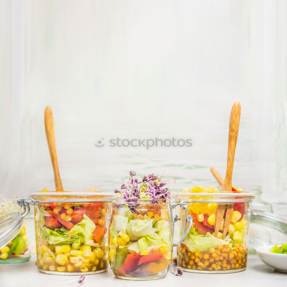 Salads in jars with vegetables, lentils, corn and sprouts