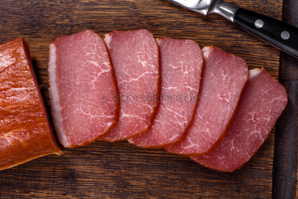 Similar – Image, Stock Photo Cutter carving slices from a whole bone-in serrano ham