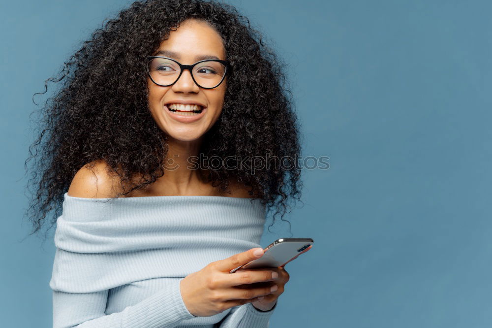 Similar – Image, Stock Photo Beautiful afro american woman using mobile in the street.