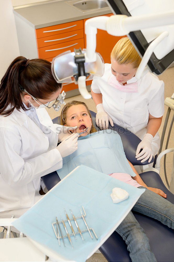 Similar – Image, Stock Photo A fragment of a dental room with a kid, lying on a dental chair, and a part of his doctors figure