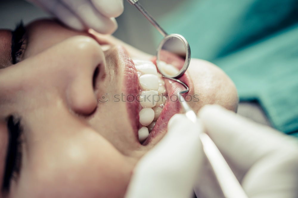 Similar – Seated young man is being examined his teeth by a dentist.