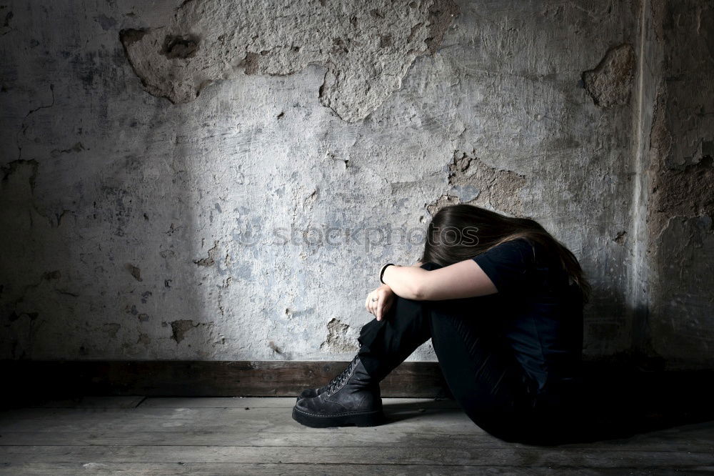 Similar – sad little girl sitting near the wall