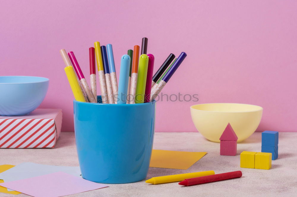 Similar – markers, crayons, pink and blue paper, scissors, eraser