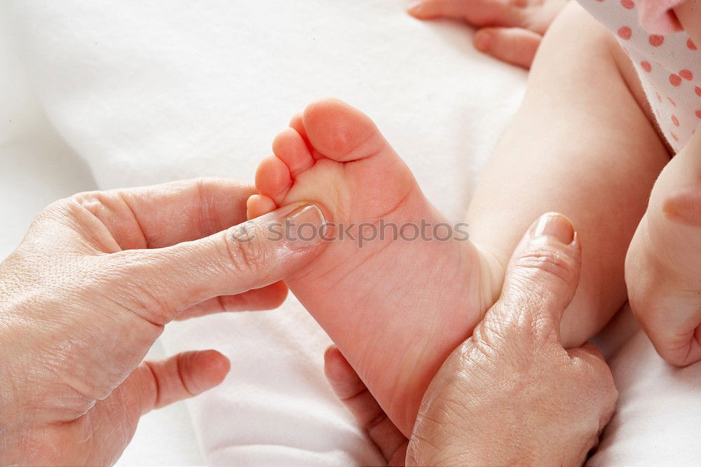 Similar – Baby girl touching hand of senior man