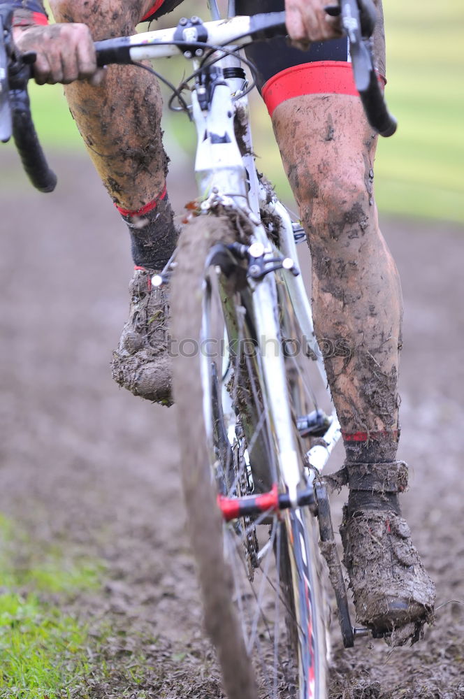 Similar – Legs in red trousers and green rubber boots jumping in a muddy puddle, so that the mud flies up