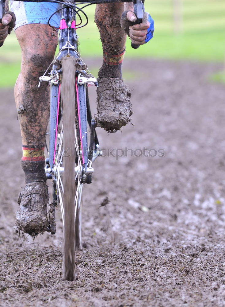 Similar – Legs in red trousers and green rubber boots jumping in a muddy puddle, so that the mud flies up