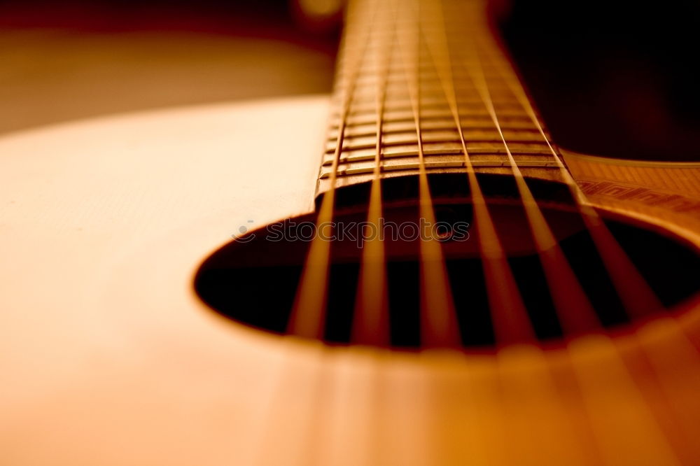 Image, Stock Photo Ukulele Hawaiian small guitar music instrument at sunset closeup photo. Beige brown gold colour palette shot with ukulele lying on windowsill in soft natural light.