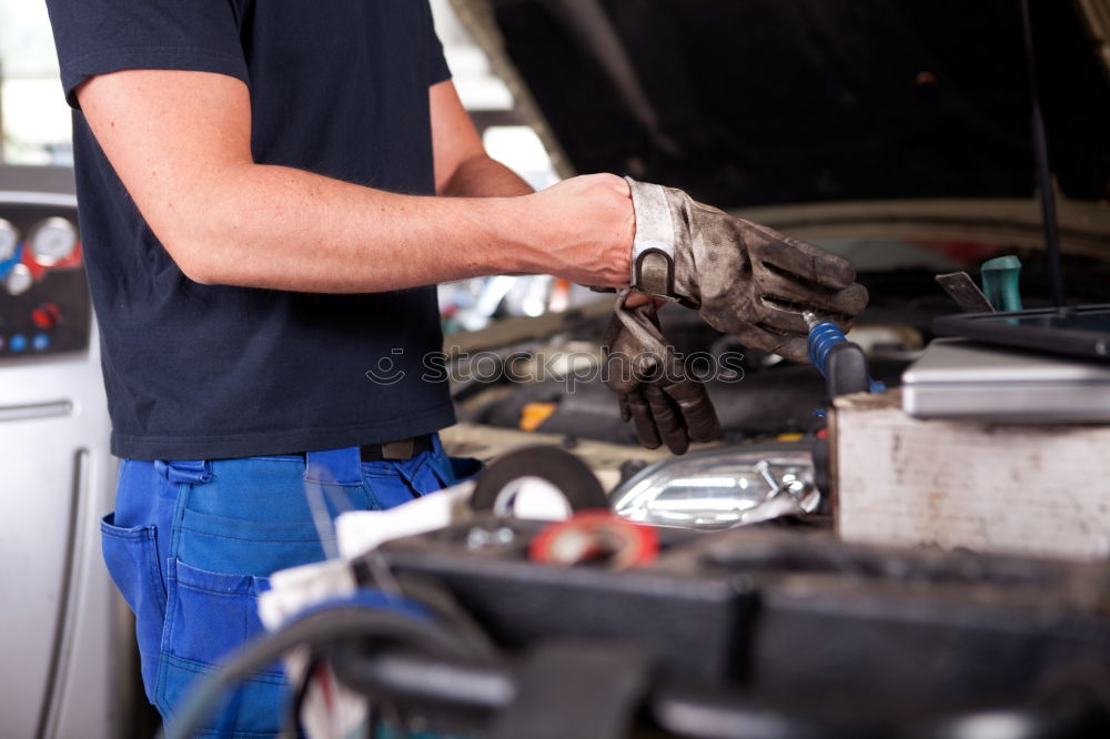 Similar – Professional Mechanic Repairing Car Engine.