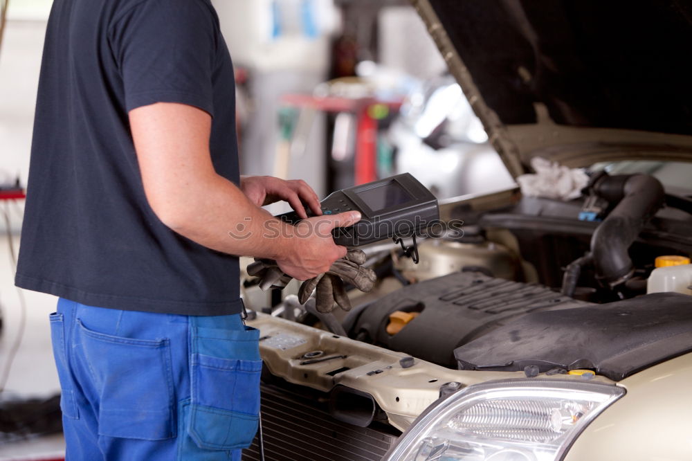 Similar – Professional Mechanic Repairing Car Engine.