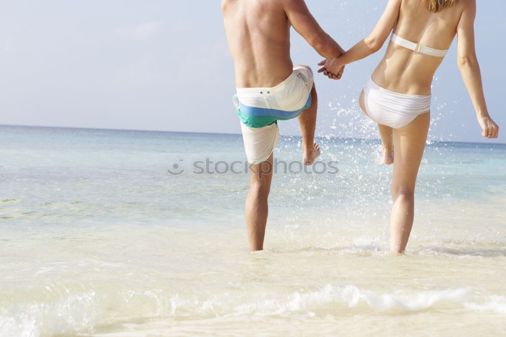 Similar – Image, Stock Photo Crop couple in swimsuit holding hands