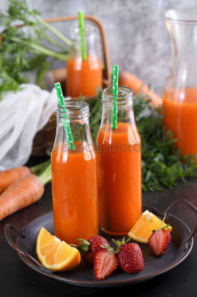 Carrot juice in a transparent little jar