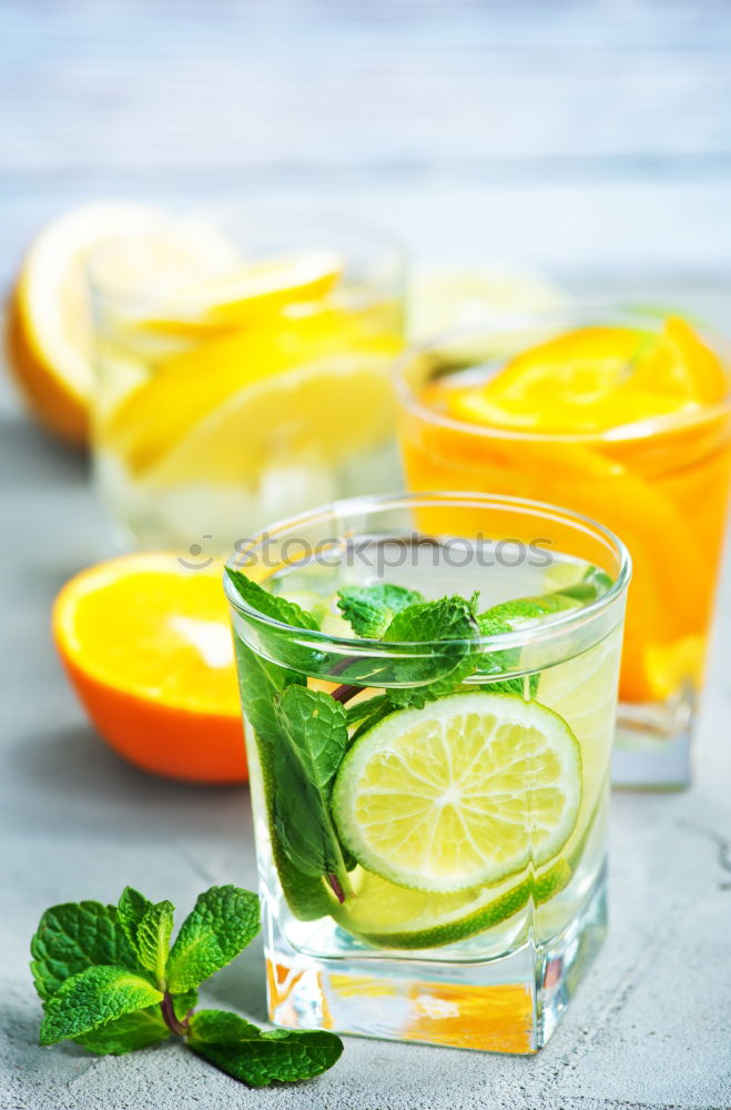 Similar – Cool soft drink with mineral water, tangerine, cucumber slices, ice cubes and green straw