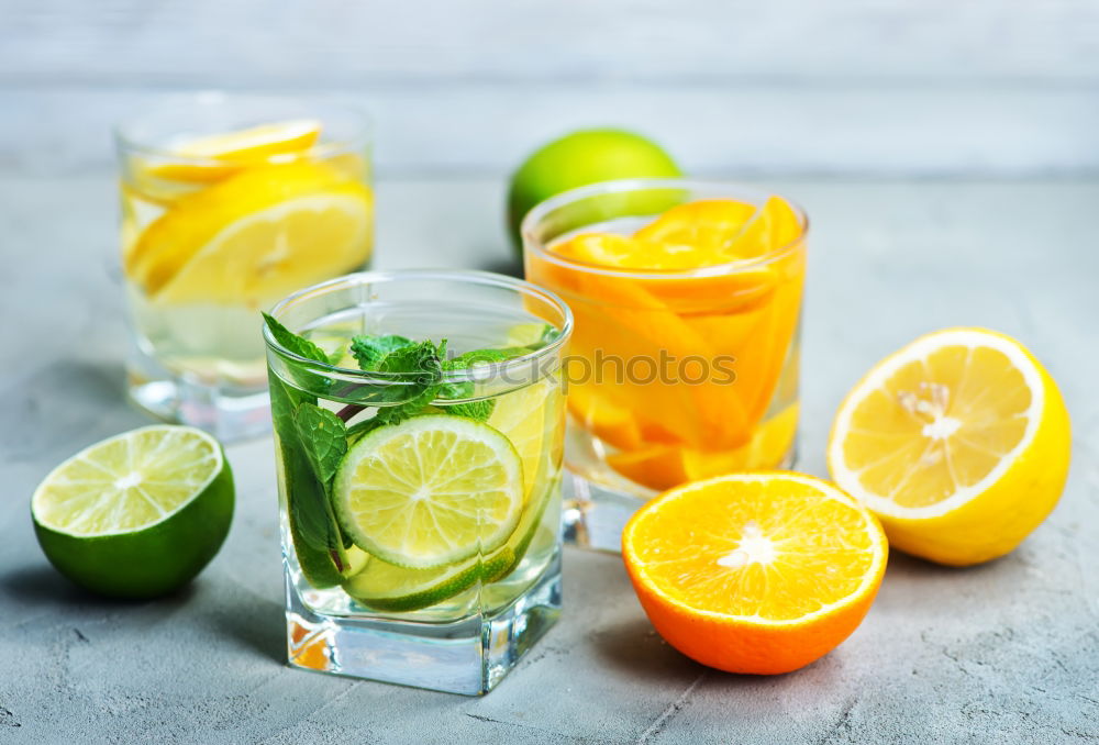 Similar – Cool soft drink with mineral water, tangerine, cucumber slices, ice cubes and green straw