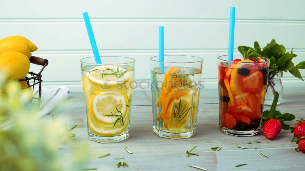 Similar – Two glasses of soft drink with honey- and watermelon, rosemary, ice cubes and drinking straw