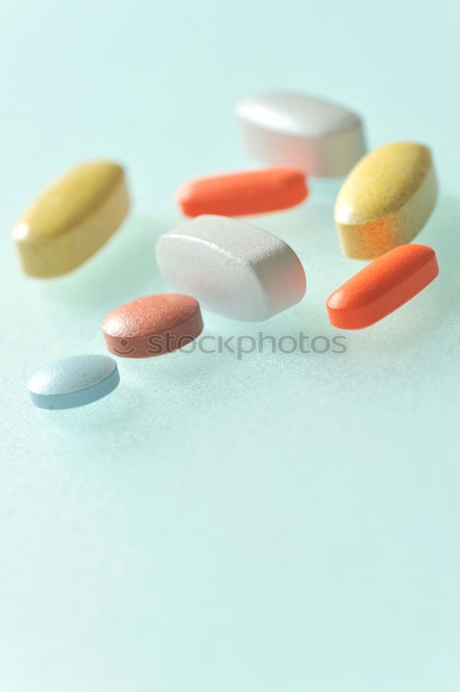 Similar – A hand in which several different colored tablets are lying; addiction problems, drug abuse, suicide