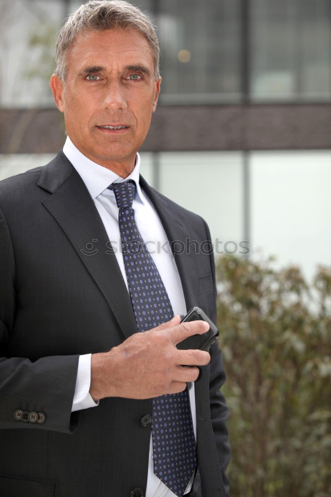 Similar – Senior businessman walking outside of modern office building