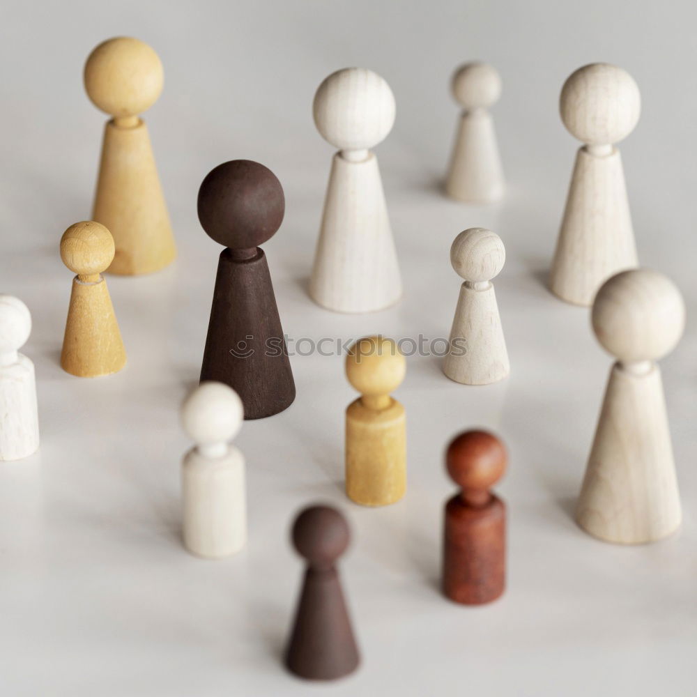 Similar – Three game pieces in German colours stand in front of a large group of game pieces in black, red, gold