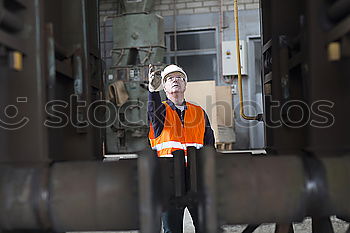 Similar – Image, Stock Photo Female mechanic operating a hoist to lift a compressor engine