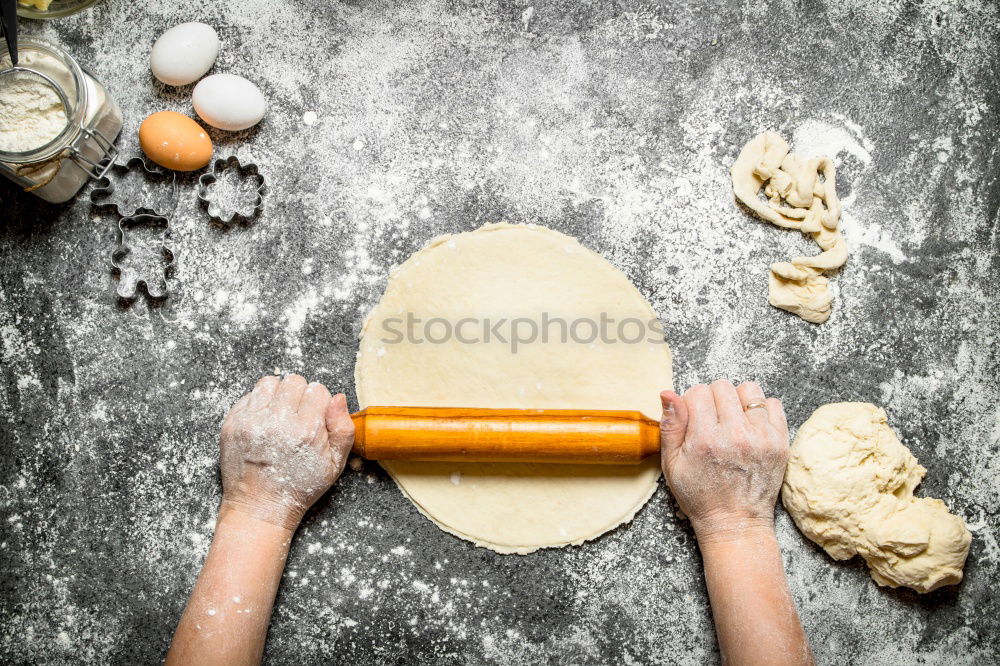 Similar – woman in bakery preparing sweets adding egg