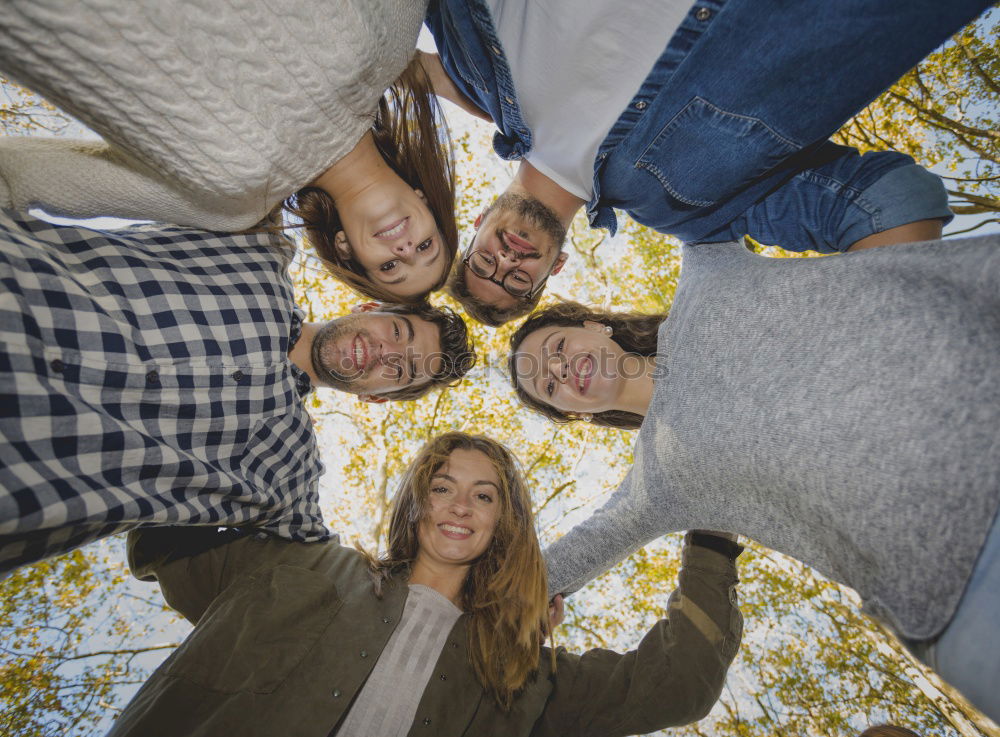 Similar – Women and men laying on grass wearing casual clothes.