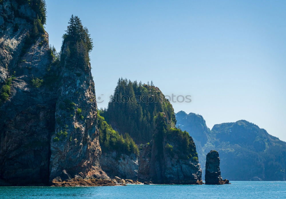 Similar – Rugged coast in the blue sea