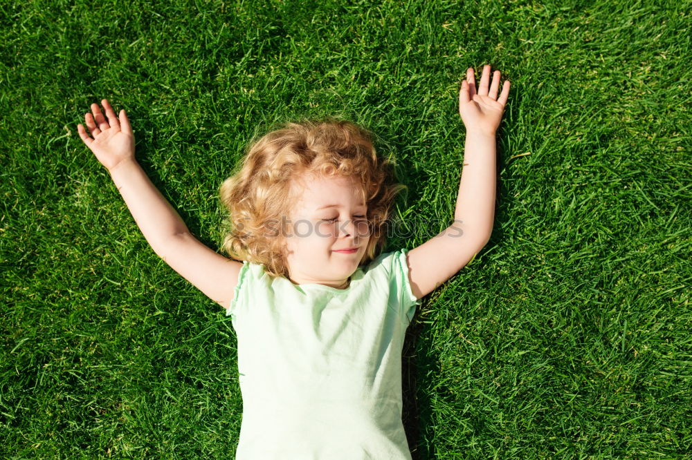 Similar – Image, Stock Photo Funny, funny, cheerful, happy, funny blonde girl outside in the garden, looks up and stretches both arms up to the tree. Little joker does nonsense, sticks out her tongue, in nature, in the park under the tree.