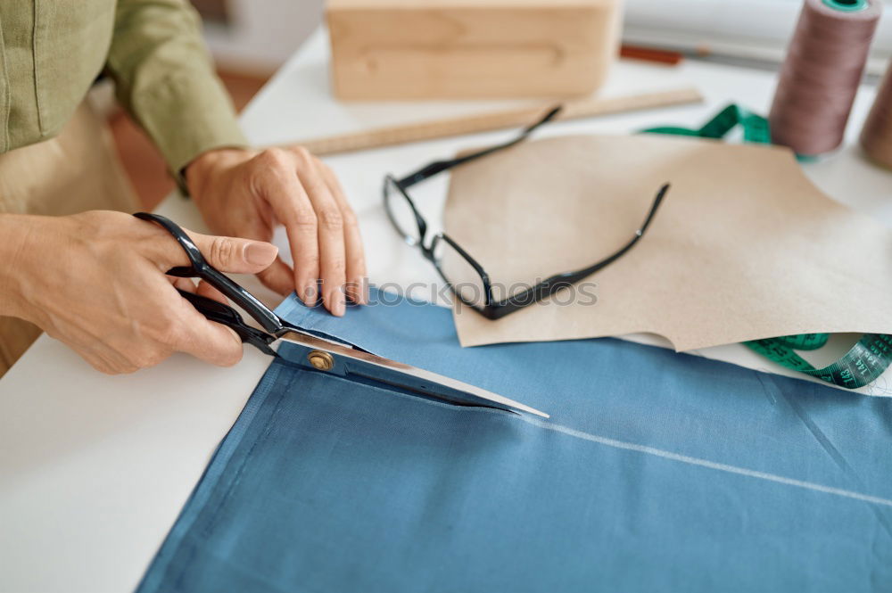 Similar – Close up on woman’s hands sewing needle and thread. Old woman working wasted hands .Tailor sewing some fabric. Details, low light, moody