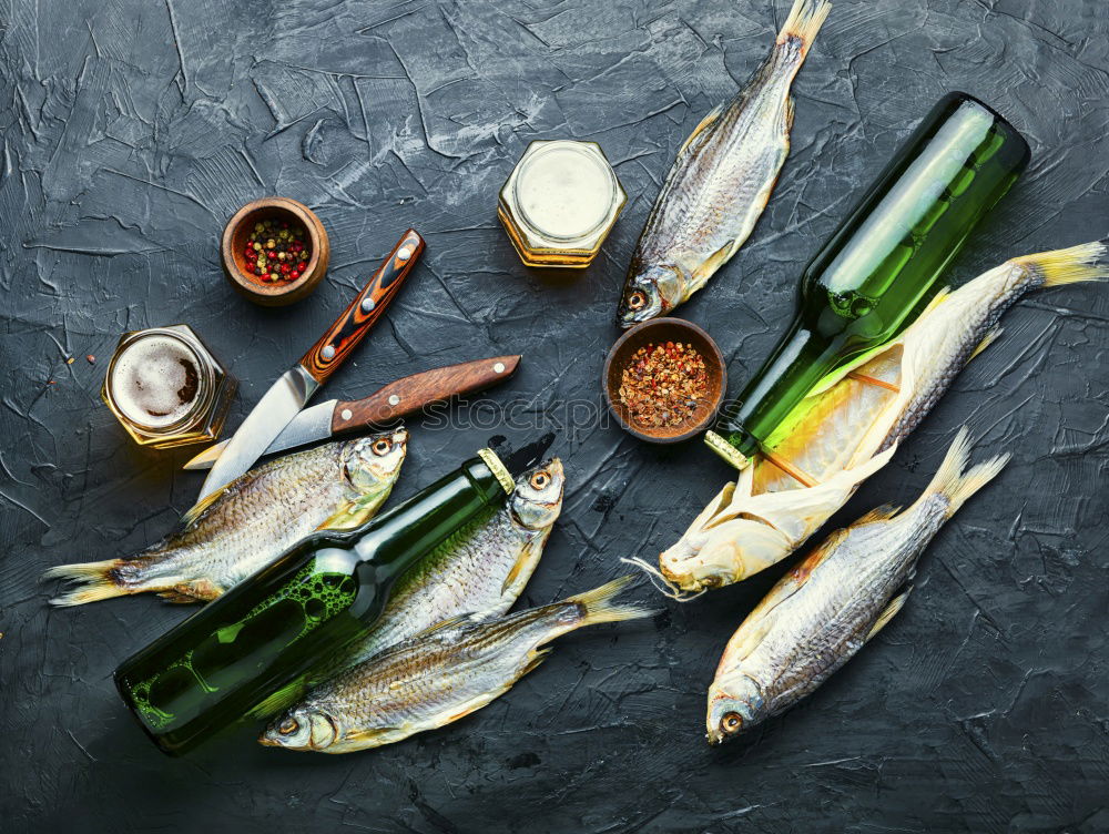 Similar – Raw fish on white paper with ingredients for cooking