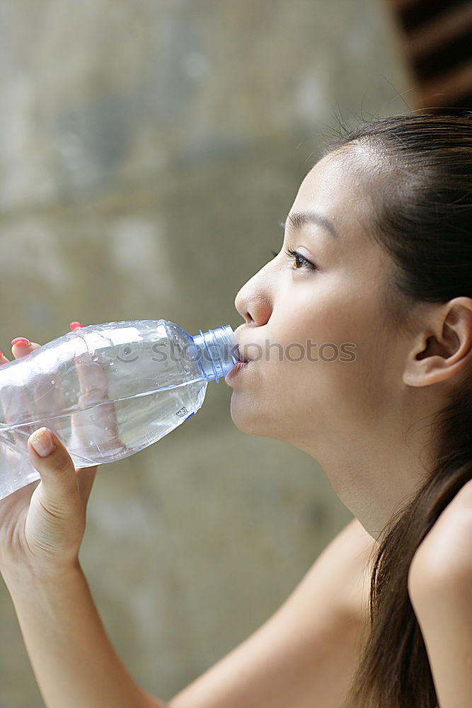 Similar – Fit sporty woman drinking water from a bottle