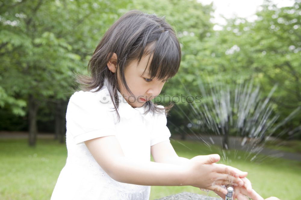 Similar – Kid girl playing with garden sprinkler