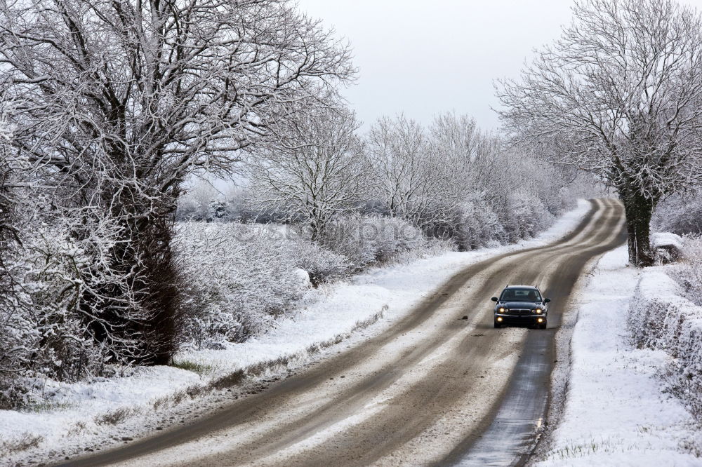 Similar – Snowy rural road at winter