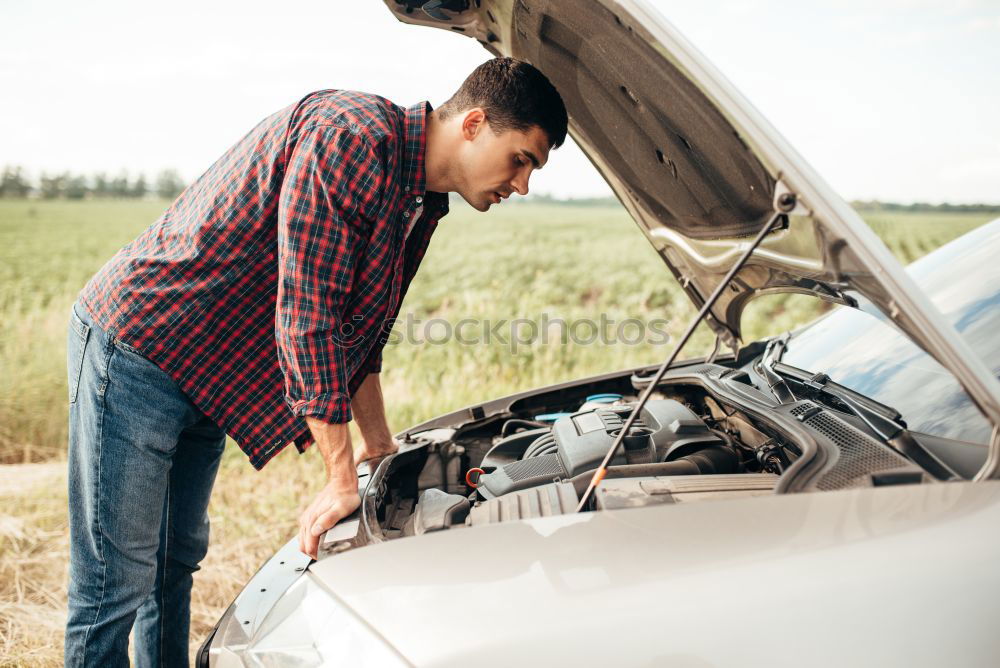 Image, Stock Photo man looks at the motor broken machine