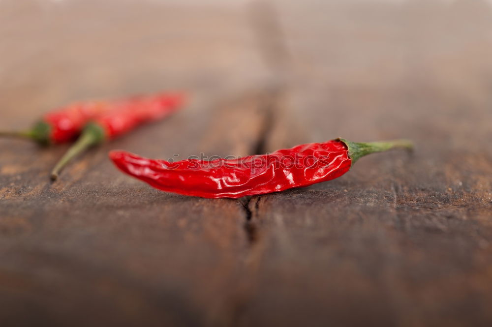 Similar – Image, Stock Photo Red hot chili peppers on a wooden background