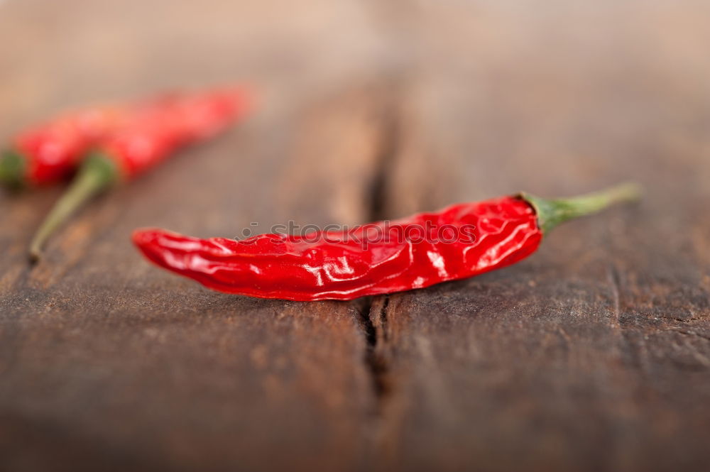 Similar – Image, Stock Photo Red hot chili peppers on a wooden background