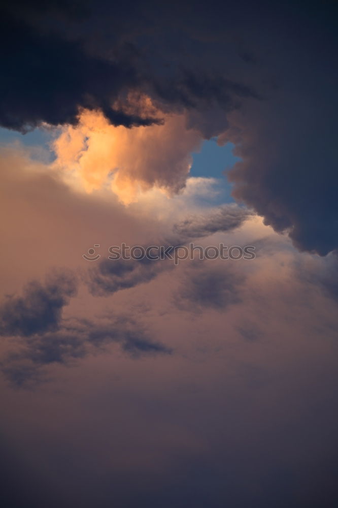 Similar – Sky colors, black clouds with gold yellow sun shimmering over the city