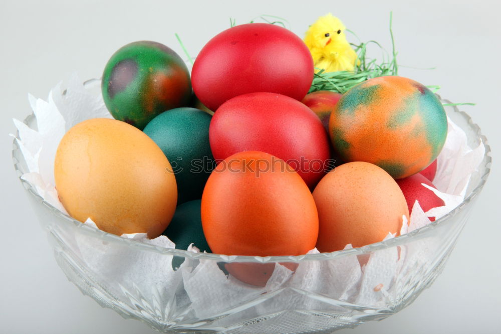 Similar – colorful Easter eggs next to natural brown chicken eggs