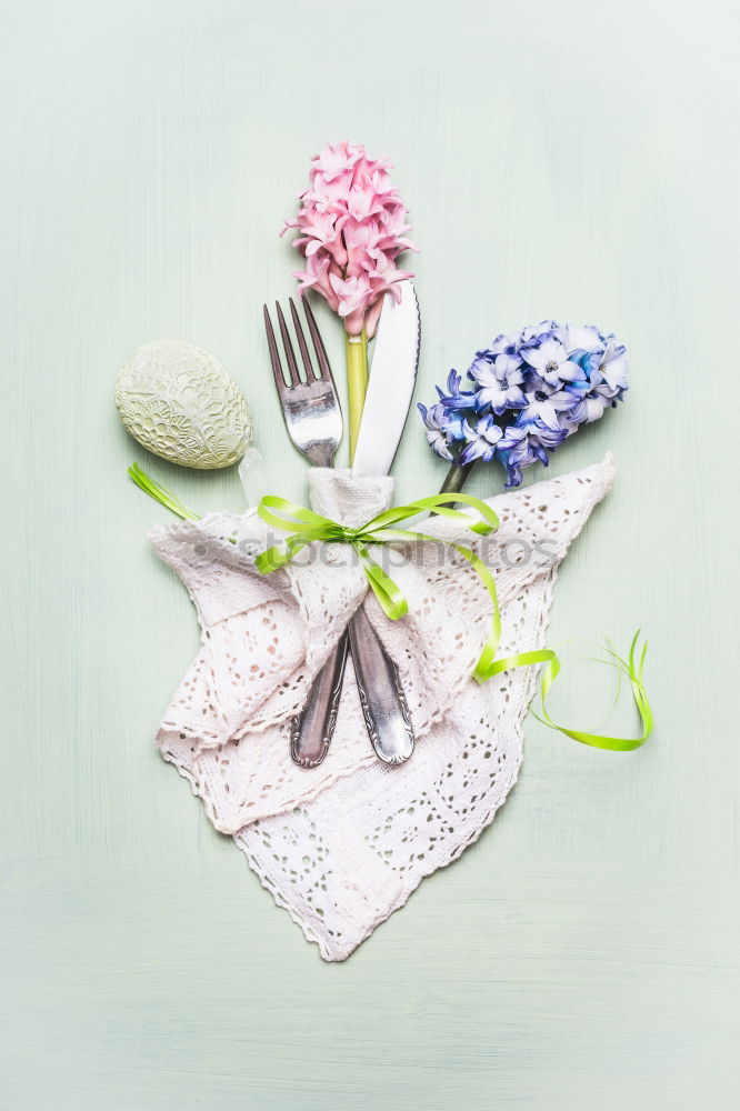 Easter table setting with flowers, decor egg and cutlery