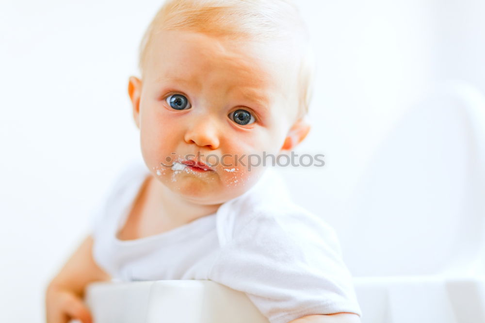 Similar – Image, Stock Photo An unfocused portrait of a blue-eyed baby, hugging its mother, who is holding it in her arms