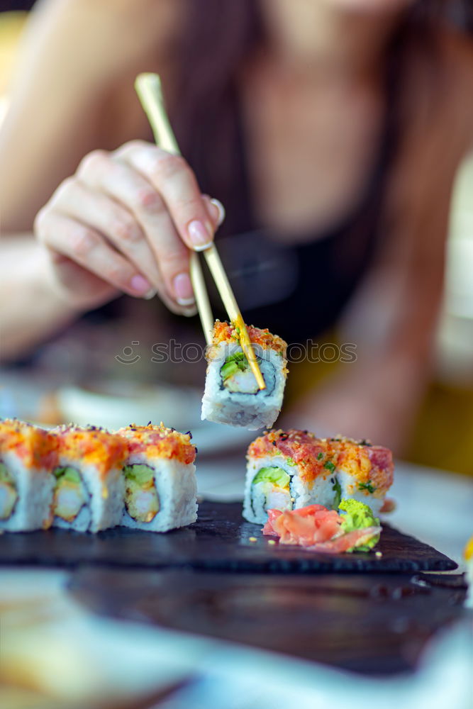 Similar – Crop woman eating sushi