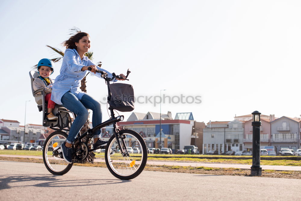 Similar – Happy family with a child riding bicycles by the city