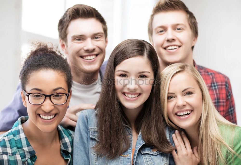 Similar – Group of multi-ethnic young people having fun together outdoors in urban background