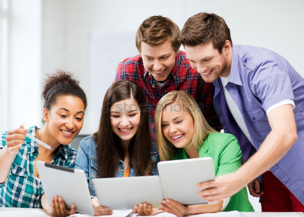 Similar – Image, Stock Photo Multi-ethnic group of young people looking at a tablet computer outdoors