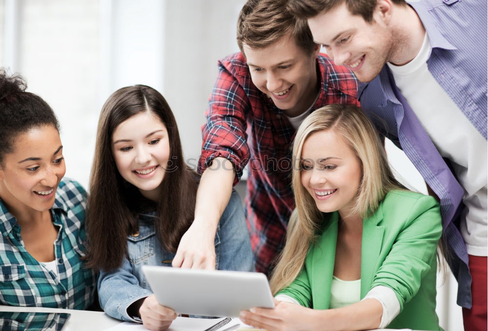 Similar – Multiracial group looking at a tablet computer outdoors