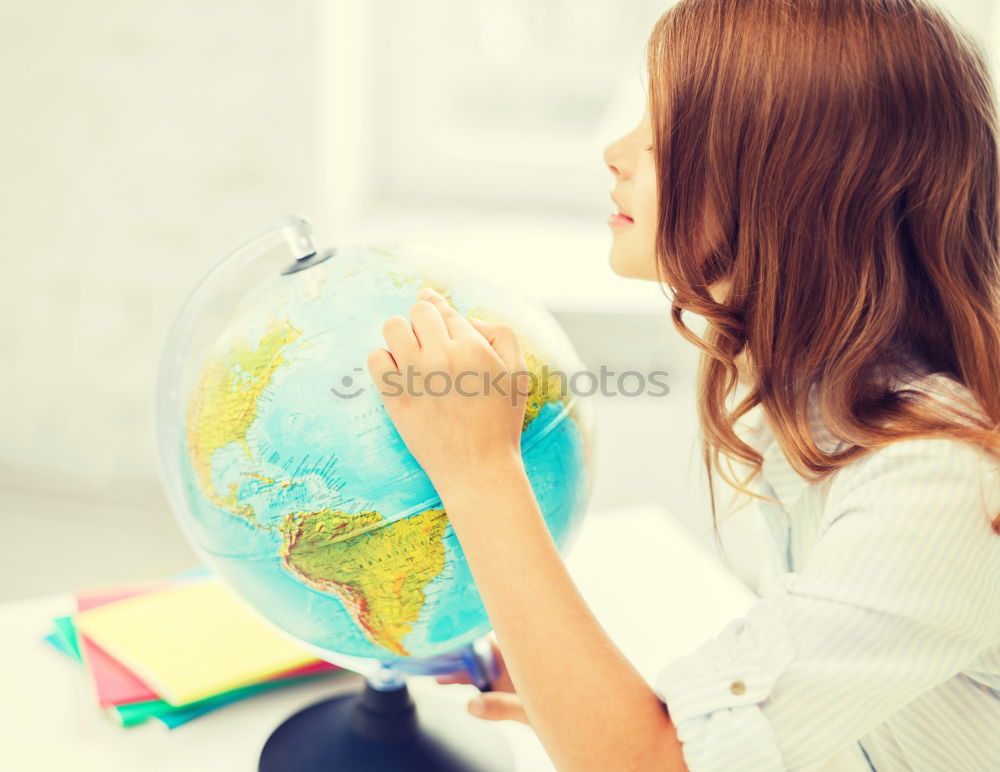 Similar – Image, Stock Photo Schoolgirl covering face with globe