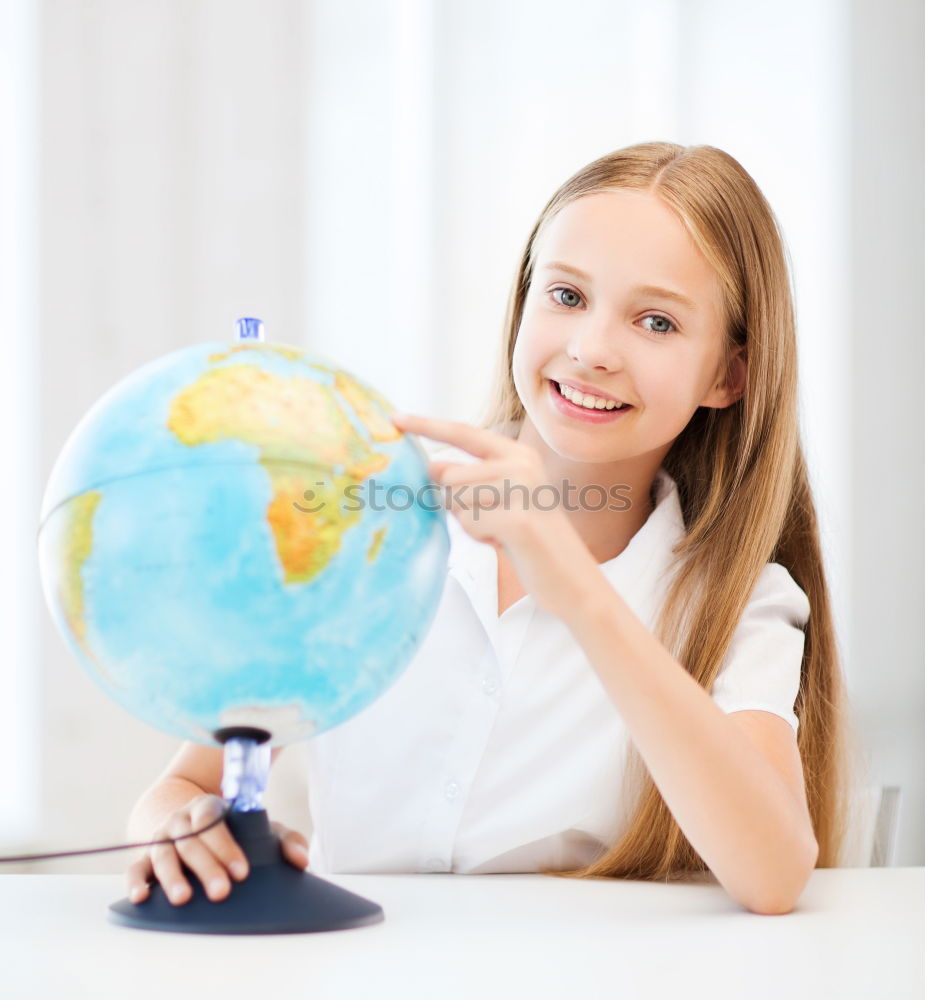 Similar – Image, Stock Photo Pupil girl pointing at globe