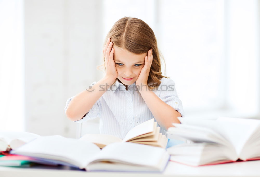 Similar – Image, Stock Photo Schoolgirl reading a book in classroom