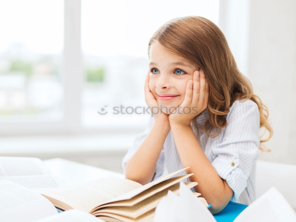 Similar – Image, Stock Photo Schoolgirl reading a book in classroom